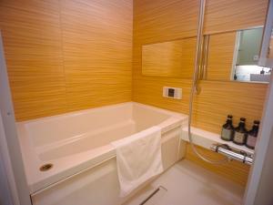 别府GRAND BASE Beppueki的设有带浴缸和淋浴的浴室。
