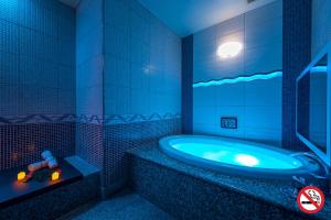 滨松HOTEL Dior7的蓝色的浴室设有浴缸,里面装有玩具车