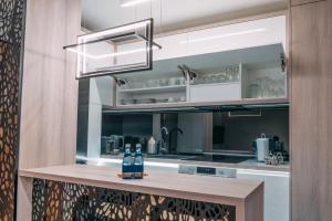克拉科夫Vistula Terraces Apartment的厨房配有带瓶子的吧台