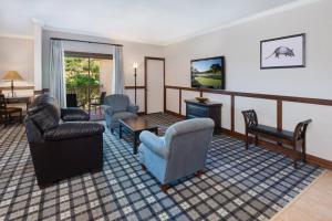 伯尼Tapatio Springs Hill Country Resort的客厅配有沙发椅和电视