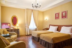 圣彼得堡阿德米拉斯卡娅酒店的酒店客房设有两张床和吊灯。
