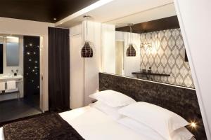 巴黎Georgette Hôtel & Restaurant的卧室配有白色的床和镜子