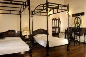 提喀迪Lake Palace的配有镜子的客房内的两张天蓬床