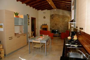 阿夏诺Sant'Ippolito的厨房以及带桌椅的起居室。