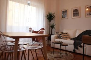 科英布拉Bela Casa - Modern Designer Chic Central Coimbra的客厅配有桌椅和沙发