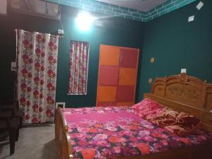 加雅Hostel Relax Homestay的一间卧室配有一张带粉色床单和绿色墙壁的床。