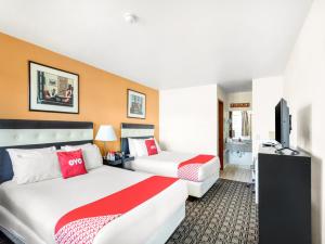 阿灵顿Arlington Motor Inn的酒店客房设有两张床和一台平面电视。