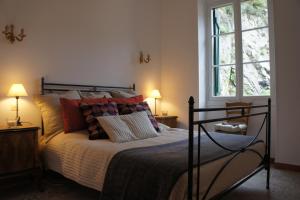 皮尼亚Casa Dolce Vita的一间卧室配有带枕头的床和2个窗户。