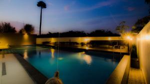 芝卡朗GTV公寓式酒店的夜间大型游泳池,灯光照亮