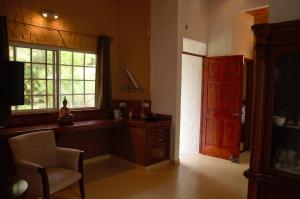 埃尔巴列德安通维拉维多利亚山林小屋的厨房配有书桌、窗户和椅子