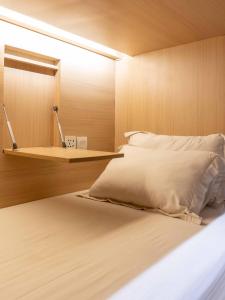 勒吉安勒吉安M精品旅舍的一间卧室配有一张带镜子和架子的床