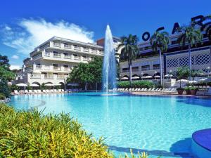 吉拉尔多特托卡勒玛酒店的一座大楼前的游泳池,带喷泉