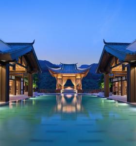 重庆重庆北碚悦榕庄的夜间带游泳池的度假村