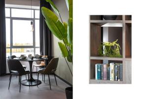 希佛萨姆Hilversum City Apartments的一间带桌子和书架的用餐室