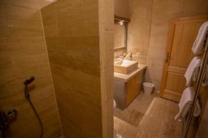 乌奇希萨尔Maze Of Cappadocia Hotel的浴室配有盥洗盆和带镜子的淋浴
