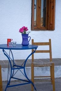 莫什劳斯Koilon Apartments的一张带花瓶和椅子的蓝色桌子