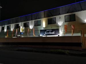 弘前市Hotel Sindbad Hirosaki-Adult Only的夜间建筑物一侧的标志