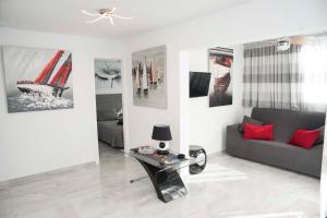 美洲海滩Playa de Las Americas Luxury Home的客厅配有沙发和墙上的照片
