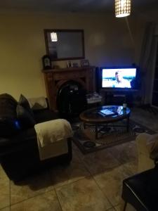 纳文Mullaghbeag Lodge的带沙发、电视和桌子的客厅