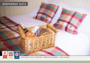 瑟斯克Morndyke Shepherds Huts的床上的柳条篮子,枕头