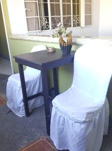 卡利博中心百汇膳食公寓酒店的窗前的桌子和椅子