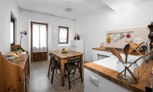 瓦拉洛Al vicolo del Gallo APPARTAMENTO的带桌子的厨房和带台面的小厨房