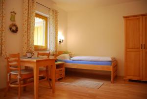 斯洛文尼亚格拉代茨罗特维尼克农场酒店的一间卧室配有一张床、一张桌子和一张书桌