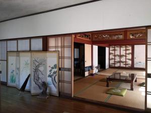 Sabae田舎生活体験福井県観光者向け古民家的一间设有桌子和玻璃门的房间