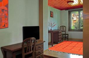 萨拉尔杜迦罗娜酒店的客厅配有书桌和电视。