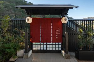 箱根Onsen Guest House Tsutaya的门上挂着红色窗帘