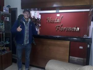 瓦拉斯Hostal Florencia的站在医院的花卉标志旁的人