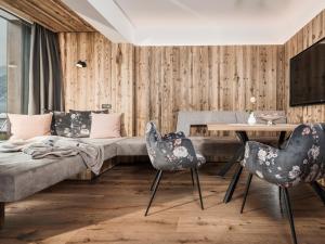 迈尔霍芬Platzhirsch Apart & Mayrhofen的客厅配有沙发和桌椅