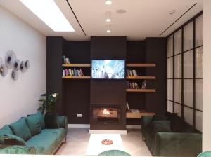 阿达莱斯Apartamentos Ardales Premium的客厅设有壁炉和电视。