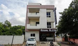 马杜赖Hotel Royal Elite Madurai的停在大楼前的汽车