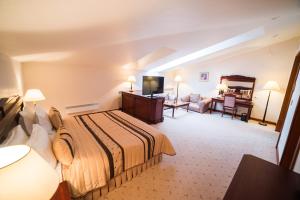 托木斯克玛吉斯切特酒店的酒店客房设有床和客厅。