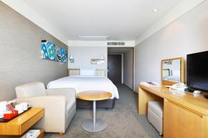 仁川市仁川机场贝斯特韦斯特尊贵酒店的酒店客房配有床、沙发和电视。