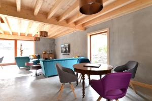 BruebachLes Granges Modernes的客厅配有蓝色的沙发和紫色的椅子