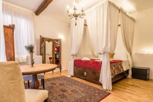 威尼斯Palazzo DaPonte的一间卧室配有一张天蓬床和一张桌子
