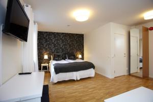 恩厄尔霍尔姆Riverside Hotel i Ängelholm的配有一张床和一台平面电视的酒店客房