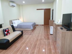 尖竹汶Na Cha Lae 1 ณ ชเล的一间配备有沙发、床和电视的客房