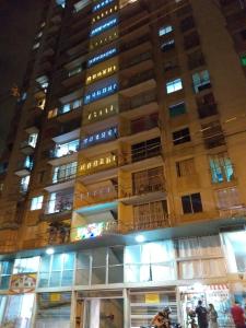 麦德林CENTRO! San Lorenzo - Downtown - Apto con 2 Hab & Parqueadero的一座高大的建筑,在它前面的人