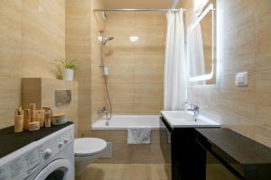 华沙Apartamenty Goka Like It Arkadia的带浴缸、盥洗盆和卫生间的浴室