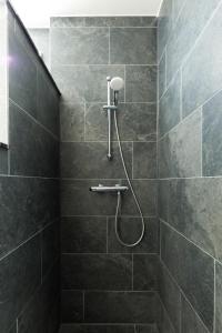 鹿特丹鹿特丹亚历山大堡垒酒店 的浴室设有灰色瓷砖淋浴。