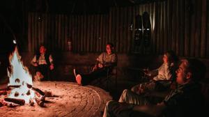 GravelotteKilima Private Game Reserve & Spa的一群人坐在火坑周围