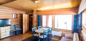 伊瓦洛乌孔湖度假村的一间带桌椅和电视的用餐室