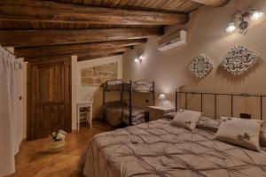 泰拉西尼乐欧司住宿加早餐酒店的一间卧室设有一张大床和木制天花板