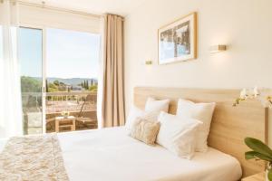 普罗旺斯艾克斯康库尔德酒店的一间卧室设有一张床,享有阳台的景色