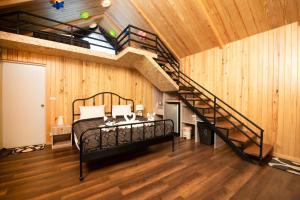慕斯Mont Blanc Glamping Khao Yai的一间卧室设有一张床和一个螺旋楼梯