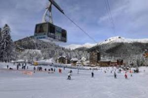 米拉Joli appartement à Murat proche du Lioran Cantal的一群人乘雪在滑雪缆车下