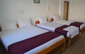 Gnaanams Hotel and Restaurant客房内的一张或多张床位